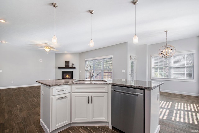 kitchen with sink, dishwasher, white cabinetry, dark wood-type flooring, and a center island with sink