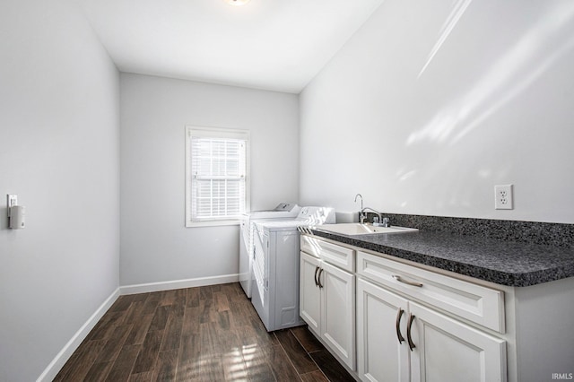 clothes washing area featuring independent washer and dryer, cabinets, sink, and dark hardwood / wood-style floors