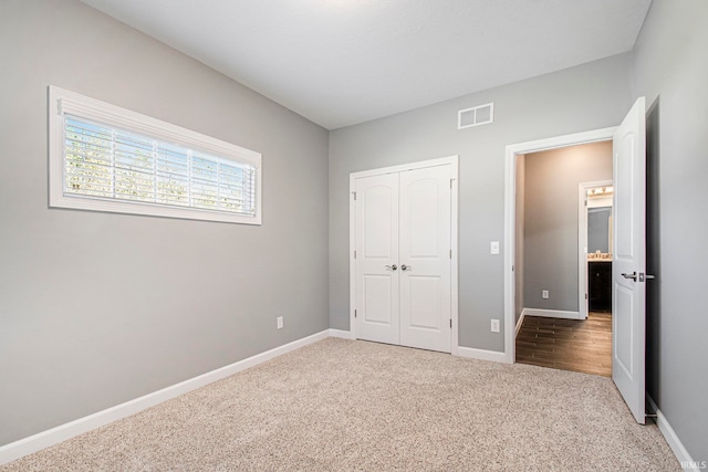 unfurnished bedroom featuring a closet and carpet flooring