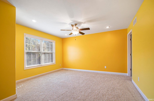 carpeted spare room featuring ceiling fan