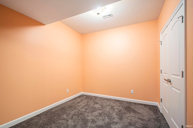 unfurnished room with carpet floors and a textured ceiling