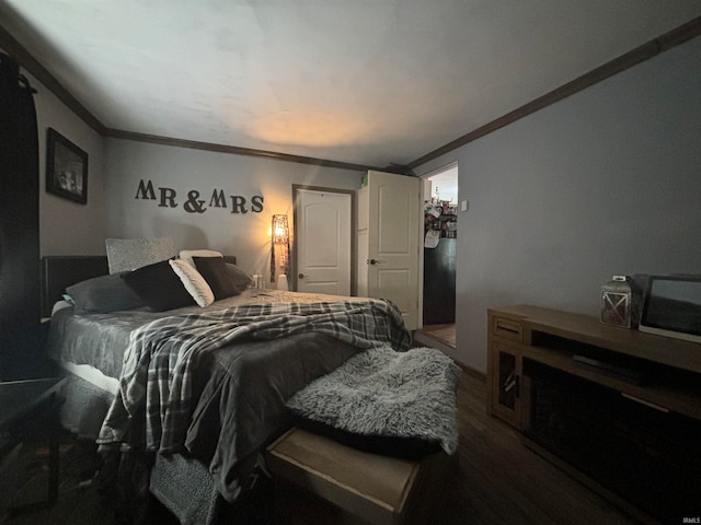 bedroom with crown molding and wood-type flooring