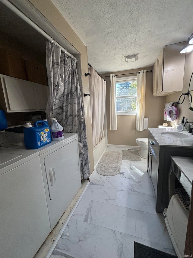 laundry room featuring a textured ceiling, sink, and washer and clothes dryer