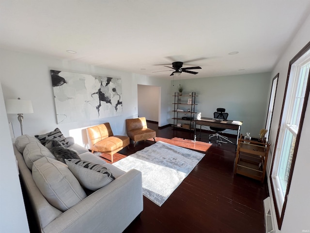 living room featuring dark hardwood / wood-style floors, a healthy amount of sunlight, and ceiling fan