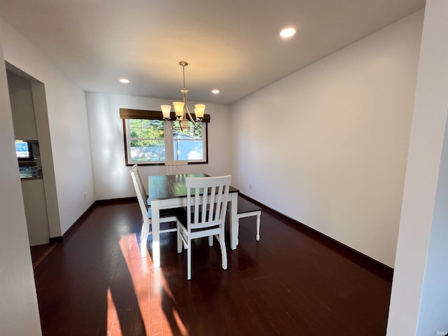 dining room with a notable chandelier and dark hardwood / wood-style floors