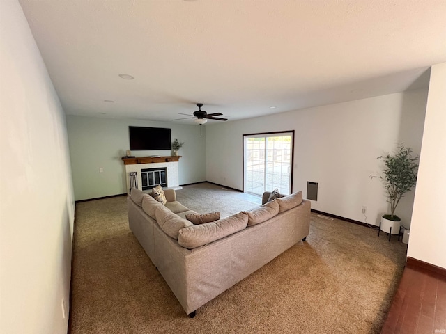 living room featuring dark hardwood / wood-style floors and ceiling fan