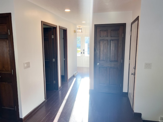 corridor featuring french doors and dark hardwood / wood-style floors