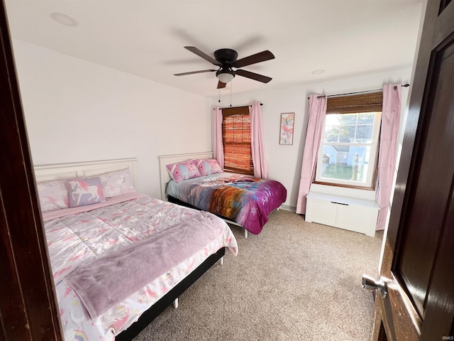 carpeted bedroom featuring ceiling fan