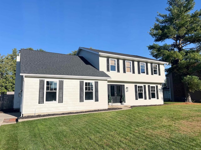 colonial-style house featuring a front lawn