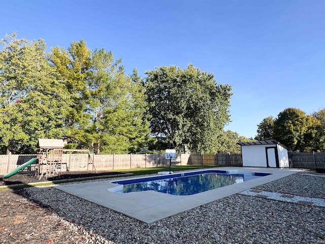 view of swimming pool featuring a storage unit and a playground