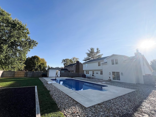 view of swimming pool featuring a patio area and a lawn