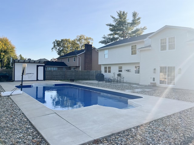 view of swimming pool featuring a patio area and grilling area