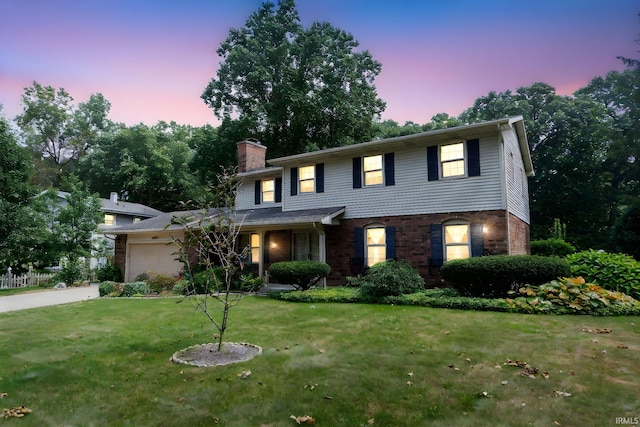 view of front of home featuring a garage and a lawn