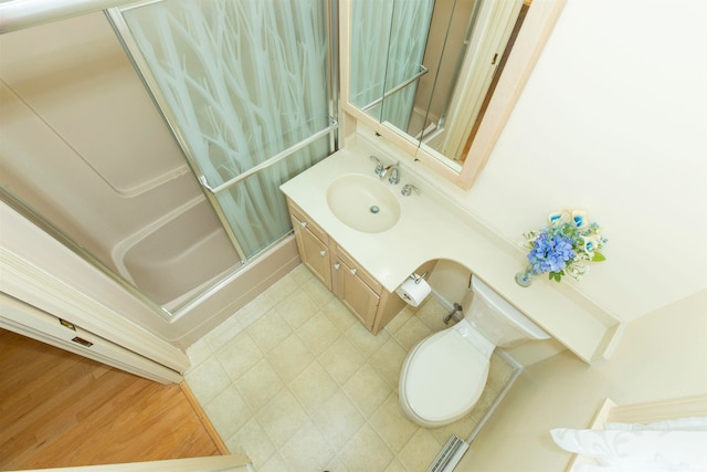 bathroom featuring vanity, hardwood / wood-style flooring, toilet, and walk in shower