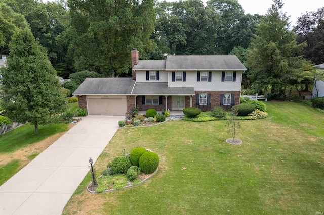 view of front of property featuring a front yard and a garage