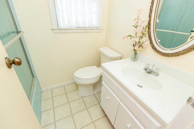 bathroom featuring vanity, walk in shower, toilet, and tile patterned flooring