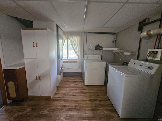 washroom with dark hardwood / wood-style floors and washer and dryer