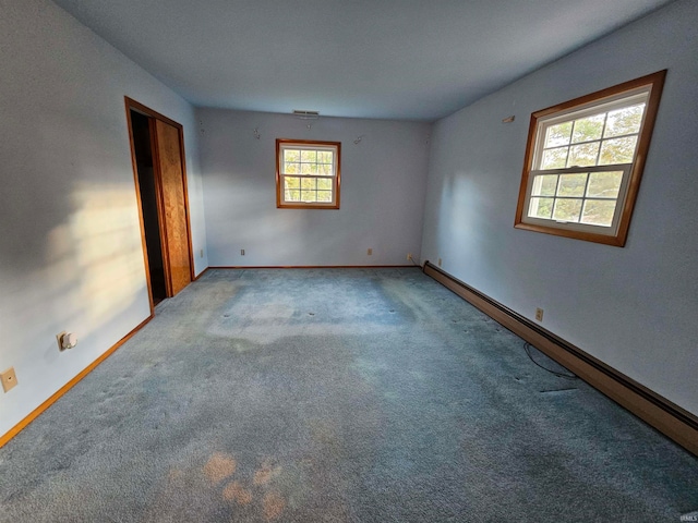 unfurnished room featuring carpet floors and a baseboard radiator