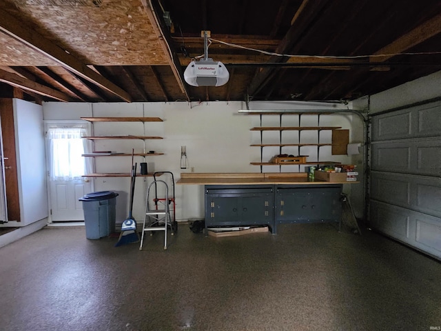 garage with a garage door opener and a workshop area