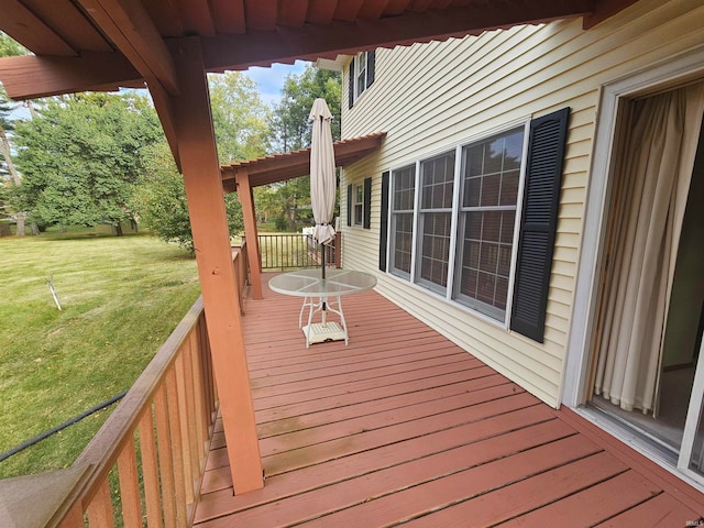 wooden terrace featuring a yard