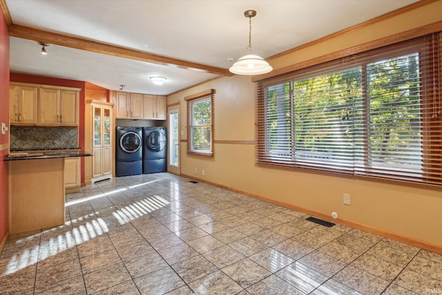 laundry area featuring crown molding, washer and clothes dryer, and light tile patterned floors