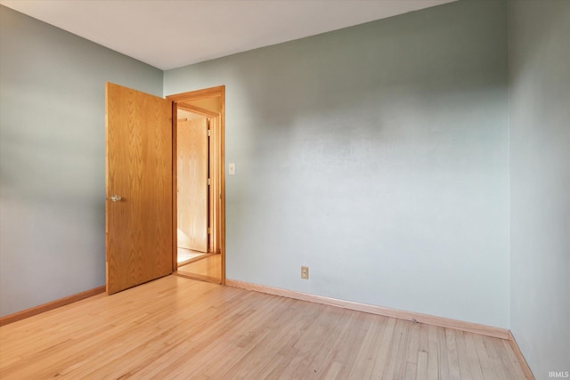 empty room with light hardwood / wood-style flooring