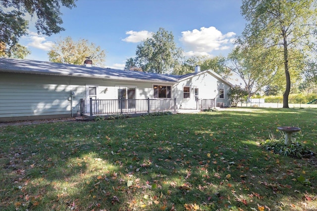 back of property featuring a yard