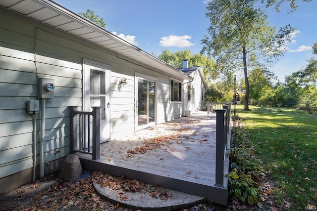 wooden deck featuring a lawn