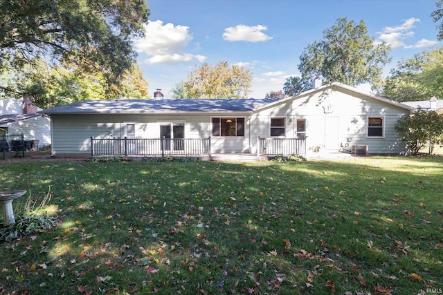 rear view of house featuring a yard