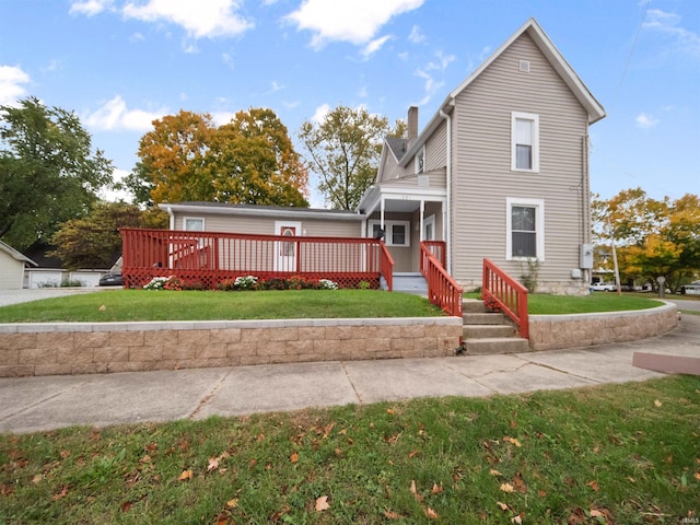 rear view of property with a lawn