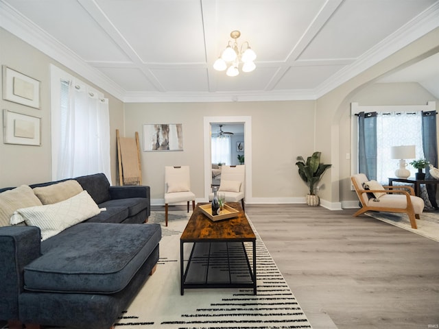 living room with light hardwood / wood-style floors, an inviting chandelier, and coffered ceiling