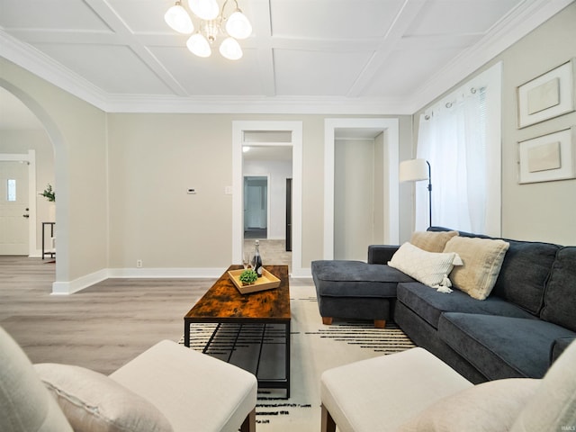 living room with ornamental molding, coffered ceiling, light hardwood / wood-style flooring, and an inviting chandelier