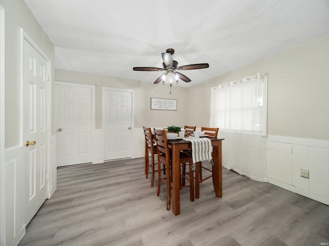 dining area with ceiling fan and light hardwood / wood-style flooring