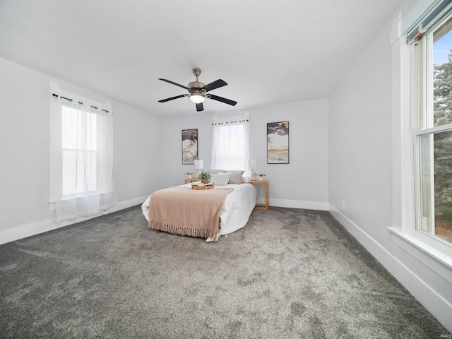 carpeted bedroom with ceiling fan and multiple windows