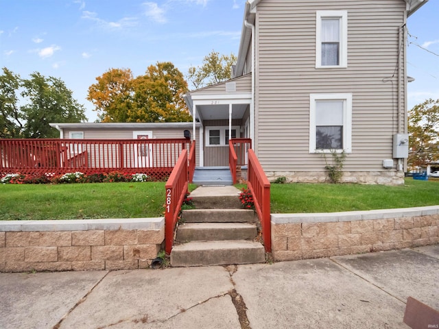 view of front of property with a front lawn and a wooden deck