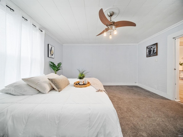 carpeted bedroom with ornamental molding and ceiling fan