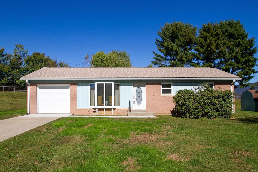 single story home featuring a front yard and a garage