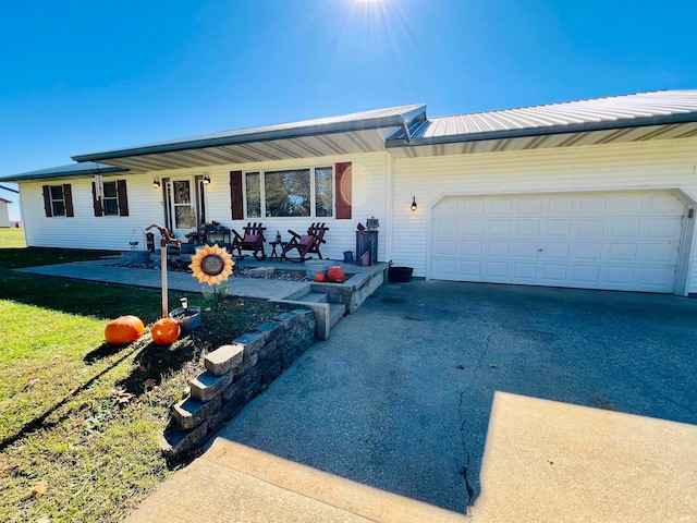 single story home with a garage and a front lawn