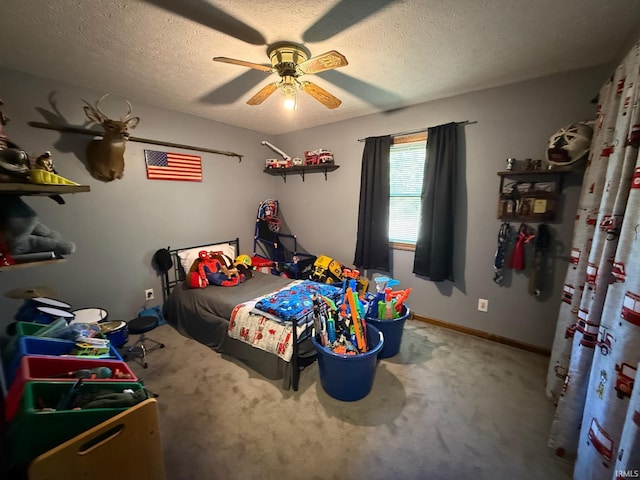 carpeted bedroom with ceiling fan and a textured ceiling