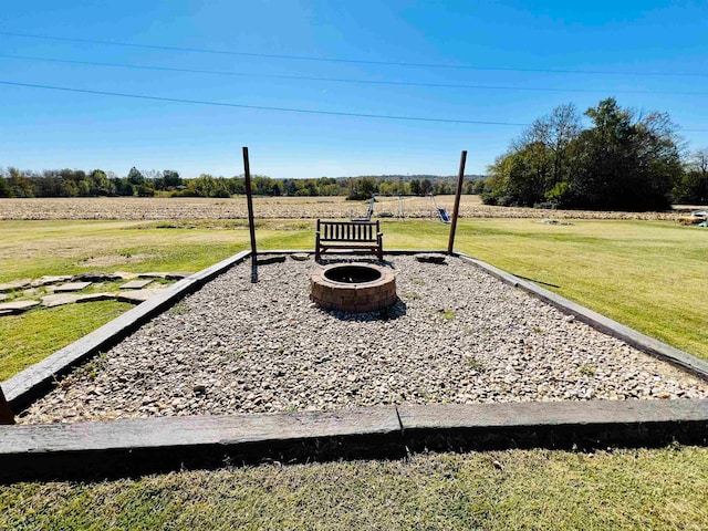 view of yard with a rural view and a fire pit