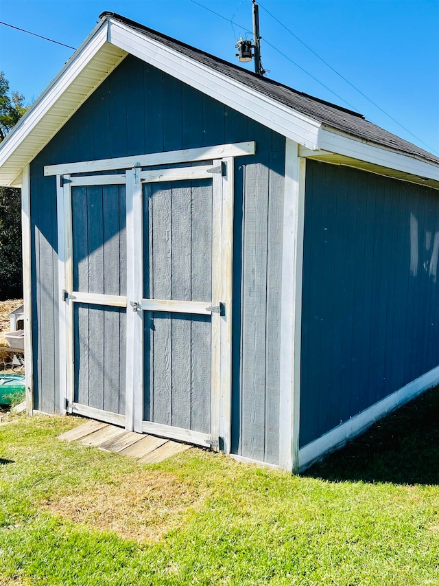 view of outdoor structure with a lawn