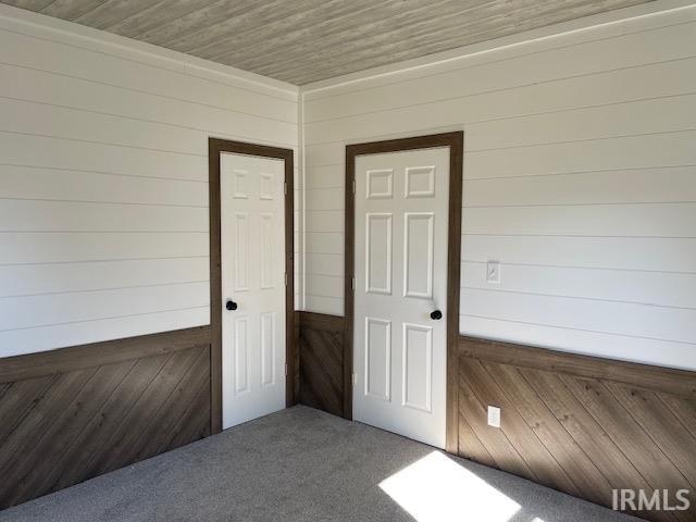 interior space with wooden ceiling and wooden walls