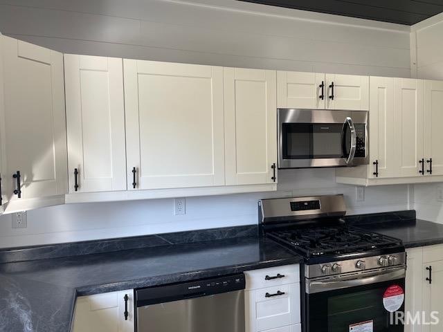 kitchen featuring stainless steel appliances and white cabinets