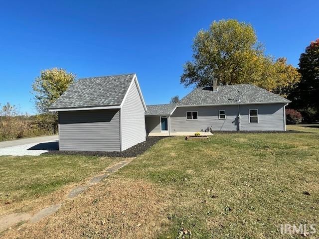 rear view of house with a yard