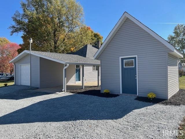 view of front of house with an outdoor structure and a garage