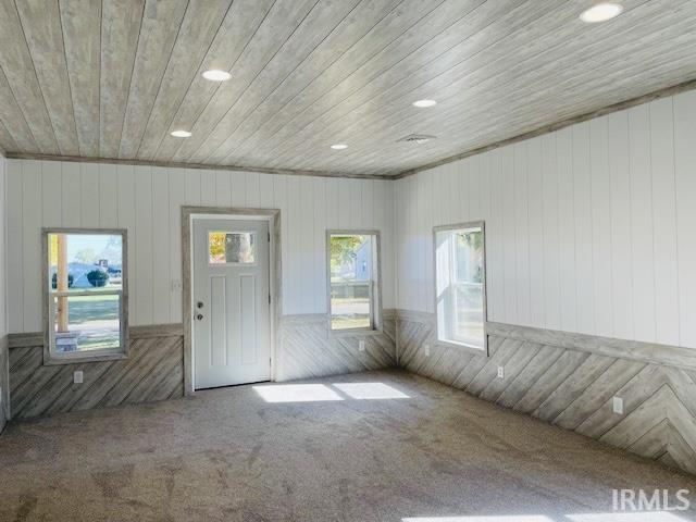 interior space featuring wood ceiling and wood walls