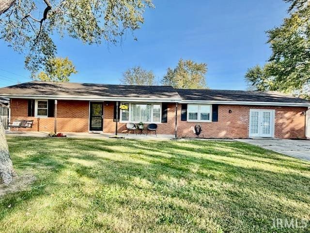 rear view of property featuring a lawn