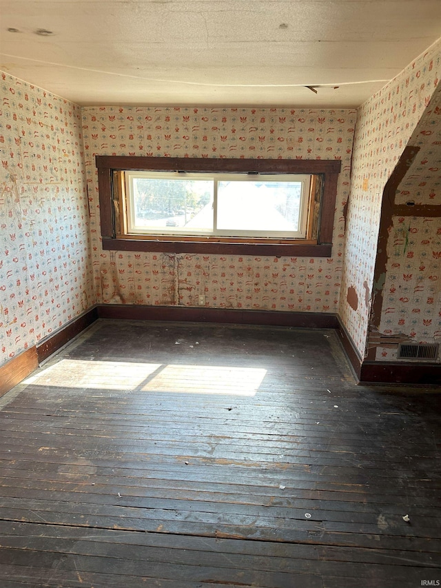 spare room featuring dark wood-type flooring