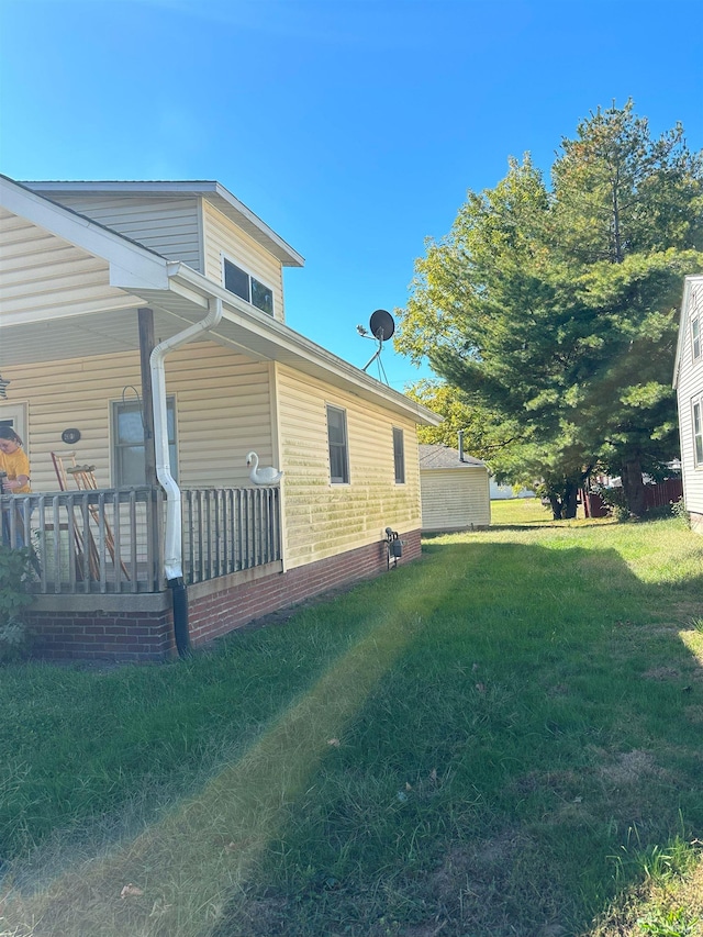 view of side of property with a lawn