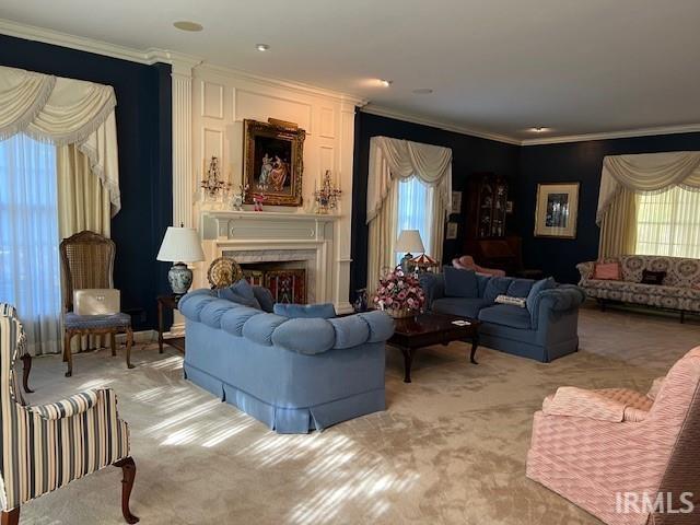 living room featuring ornamental molding, light colored carpet, and plenty of natural light